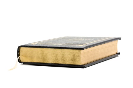 Vintage black book with gold over white backgroundの写真素材