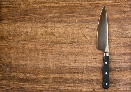 Knife on rustic kitchen table with copy spaceの写真素材
