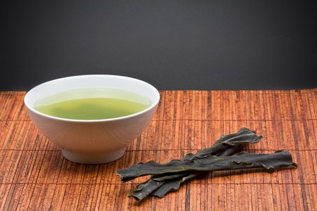 Kombu broth and dried kombu on bamboo matの写真素材