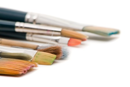 Assorted paintbrushes close up over white background with shallow depth of fieldの写真素材