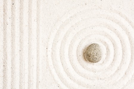 Close up of sand zen garden with stoneの写真素材
