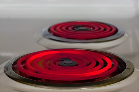 Hot red glowing electric burner - energy waste conceptの写真素材