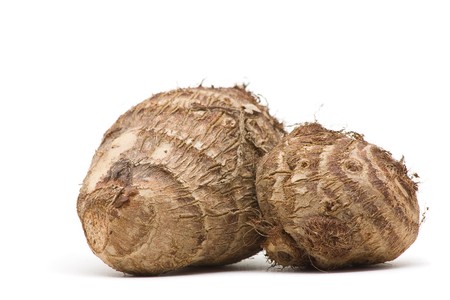 Fresh whole taro root over white backgroundの写真素材
