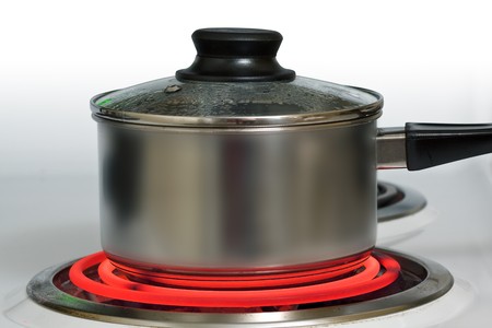 Brushed steel pot on red hot electric stove
