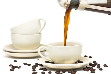 Pouring fresh brewed coffee into ceramic cupの写真素材