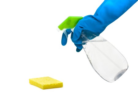 Hand in rubber glove using cleaner with sponge