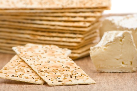 Close up of sesame crackers with cream cheese on wooden backgroundの写真素材