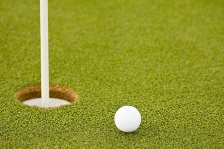 Golf ball on green with copy spaceの写真素材
