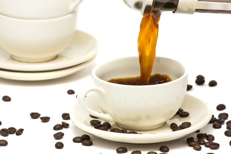 Pouring fresh brewed coffee into ceramic cupの写真素材