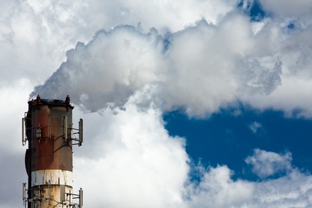 Industrial smoke stack with large white smoke cloud