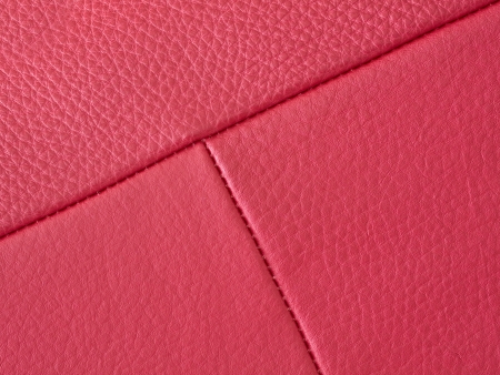 Close up of red leather texture with stitching