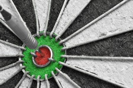 Single dart in the bulls eye on a dart boardの写真素材