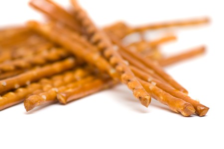Salted bread stick snack with selective depth of field over white backgroundの写真素材