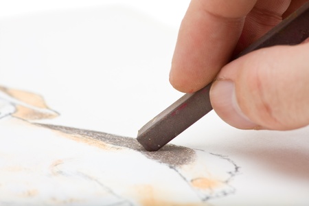 Close up of artists hand painting with pastel chalkの写真素材