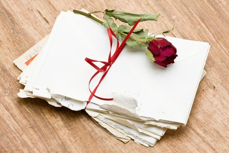 Vintage love letters with red rose over wood backgroundの写真素材