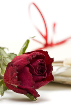 Red rose in front of a stack of love letters with selective focusの写真素材