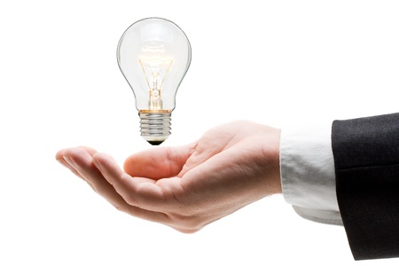 Business man holding light bulb in his hand - creativity conceptの写真素材