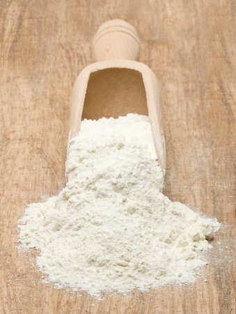 Wooden scoop with flour on wood tableの写真素材