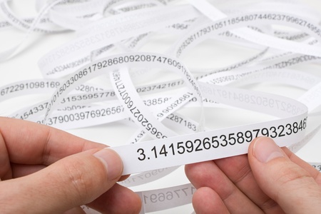 Researcher holding start of printout of the number PIの写真素材