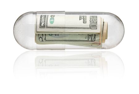 Dollar bills in medicine capsule - healthcare costs conceptの写真素材