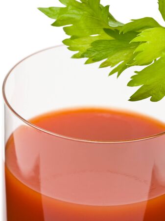 Bloody mary - mix drink from vodka and tomato juice on white background; focus on front of the glassの写真素材