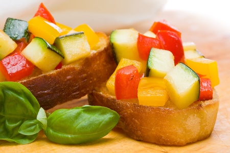 Delicious bruschetta from grilled zucchini and bell pepper on toasted breadの写真素材