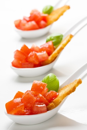 Delicious tomato bruschetta served in appetizer spoonsの写真素材
