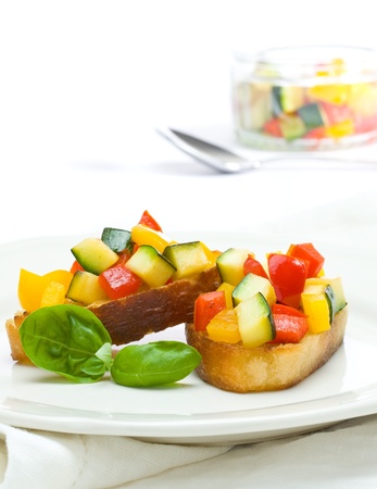 Delicious bruschetta from grilled zucchini and bell pepper on toasted breadの写真素材