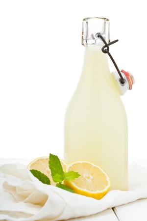 Fresh homemade bottle of lemonade on wooden tableの写真素材