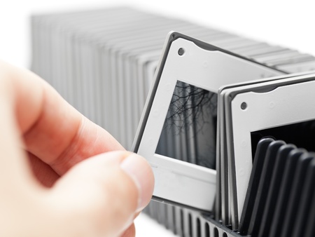 Hand picks transparency slide from projector trayの写真素材