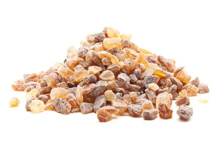 Organic rock candy sugar over white backgroundの写真素材