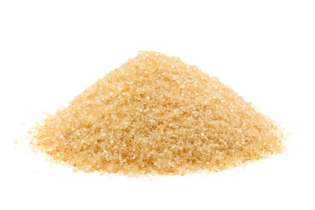 Heap of organic brown cane sugar over white backgroundの写真素材