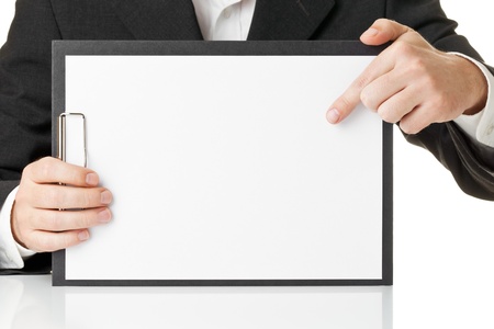Businessman pointing onto paper on blank clipboard with copyspaceの写真素材