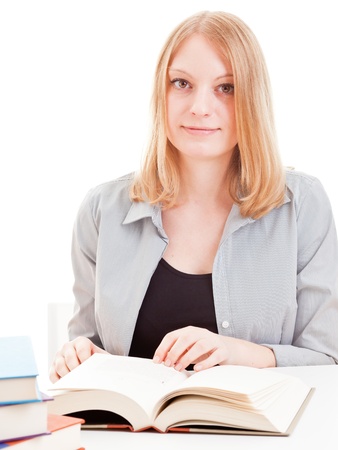 Young attractive female student reading book isolated on white backgroundの写真素材