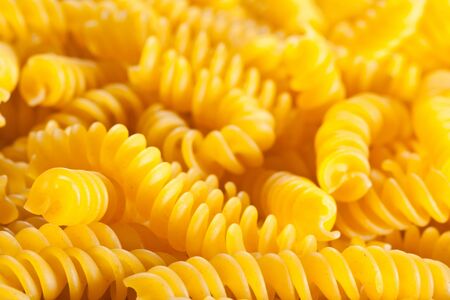 Background from raw italian spirelli  fusilli  pastaの写真素材