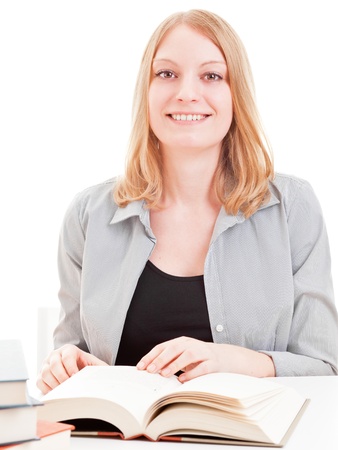 Young attractive female student reading book isolated on white backgroundの写真素材