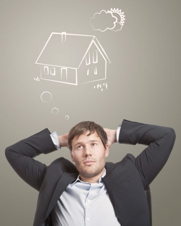 Young man thinking about his dream houseの写真素材