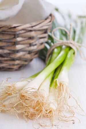 Spring onions  green onions  on wooden tableの写真素材