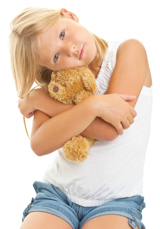 Young girl with teddy bear isolated on white backgroundの写真素材