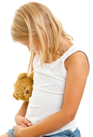 Young girl with teddy bear isolated on white backgroundの写真素材
