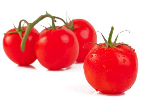 Fresh organic tomatoes with water drops isolated on white backgroundの写真素材