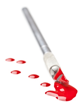 Stainless steel scalpel covered in blood isolated on white backgroundの写真素材