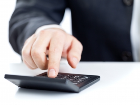 Business finance man calculating budget numbers with calculatorの写真素材