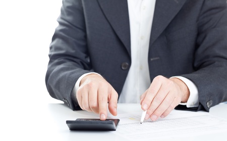 Business finance man calculating budget numbers with calculatorの写真素材
