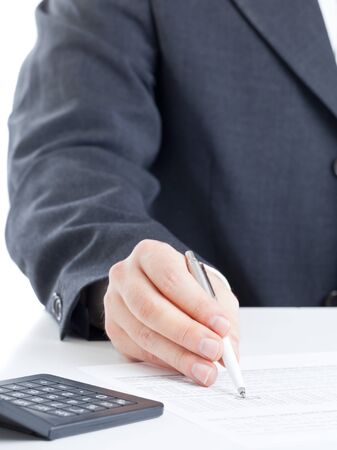 Business finance man calculating budget numbers with calculatorの写真素材