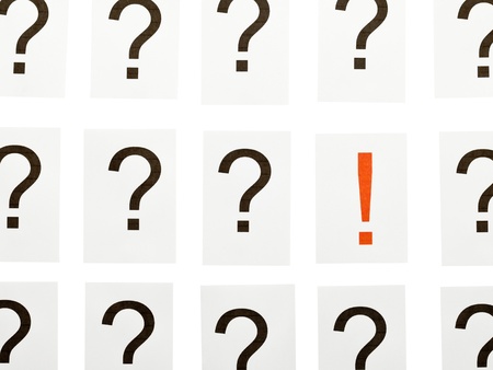 Single exclamation mark between a lot of question marks - solution or idea conceptの写真素材