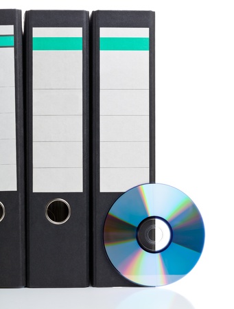 Ring binder with compact disc over white background - digital storage conceptの写真素材