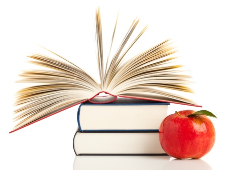 Open book with stack of books with apple - education and nutrition conceptの写真素材