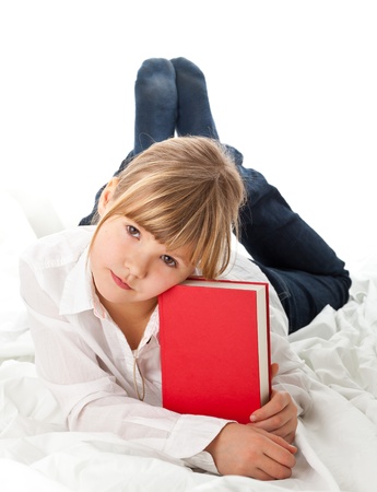Girl on bed reading book - education or knowledge conceptの写真素材