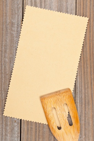 Empty paper for recipe with wooden cooking utensils on kitchen tableの写真素材